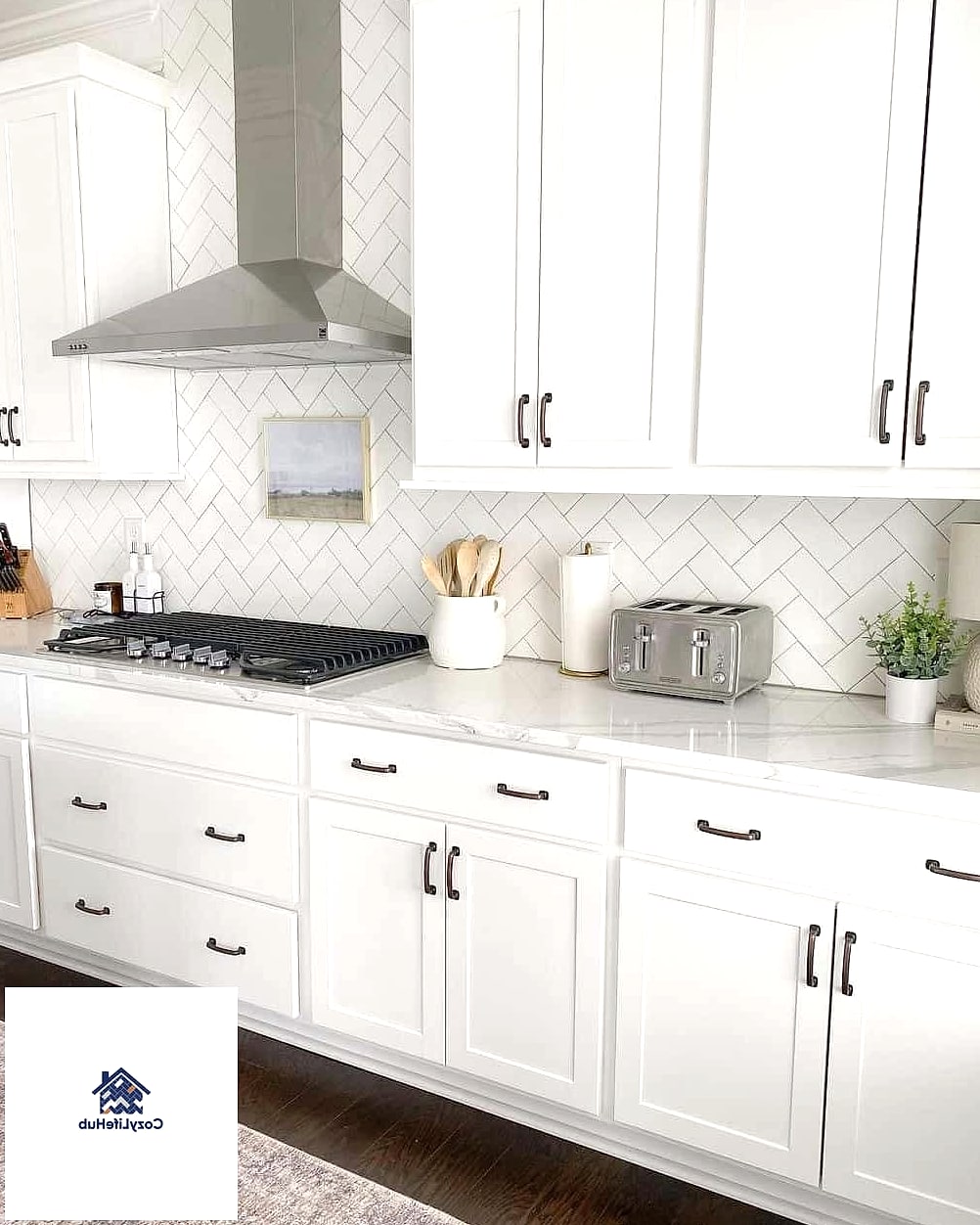 White Cabinets with a Herringbone Tile Backsplash